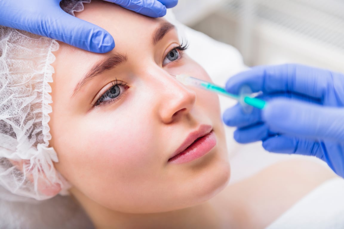 Woman receiving beauty plastic injection on her nose